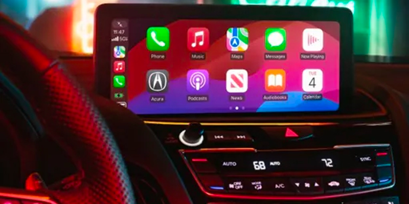 A 2025 Acura RDX dashboard display showing Apple CarPlay with apps like Phone, Music, and Maps.