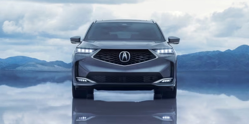 Front view of a 2026 Acura MDX A-Spec Advance Package against a mountain backdrop.