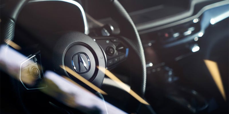interior view of the drivers console and steering wheel featuring the airbag of a 2025 Acura MDX